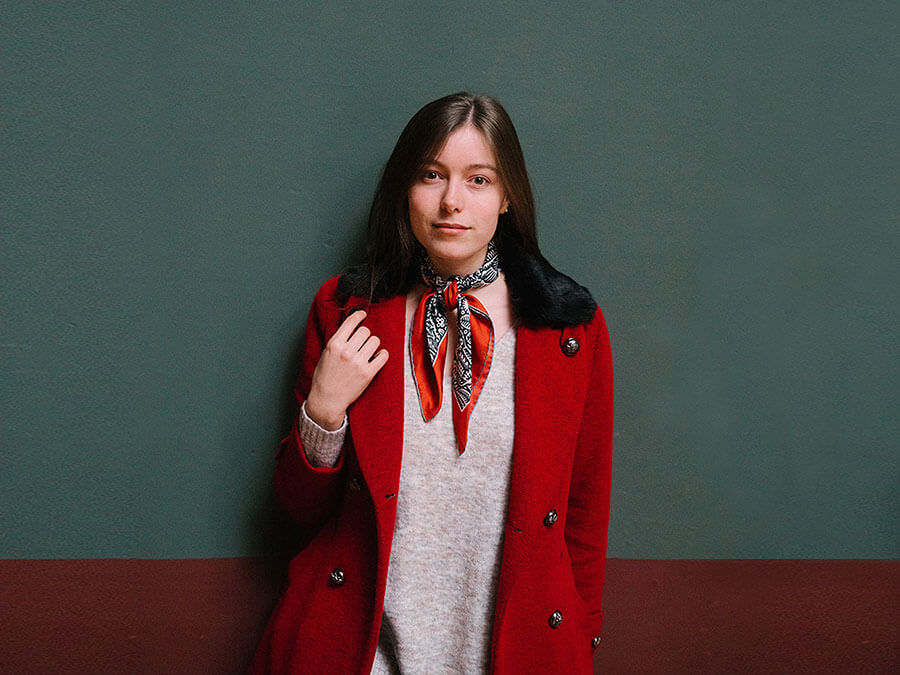 navy and red silk scarf on a woman in red coat