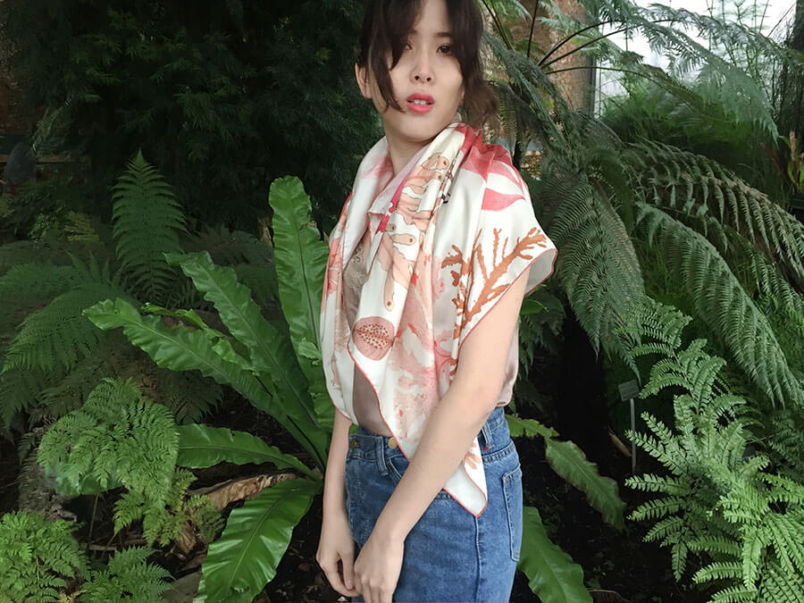 algae printed white scarf on a woman in exotic garden