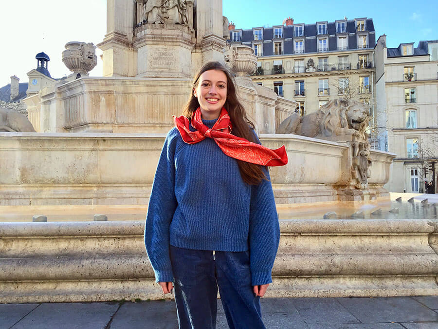 Parisian young lady wearing red silk scarf effortlessly beautiful