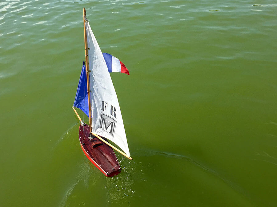 a skiff with french glad and mont koiji logo sailing