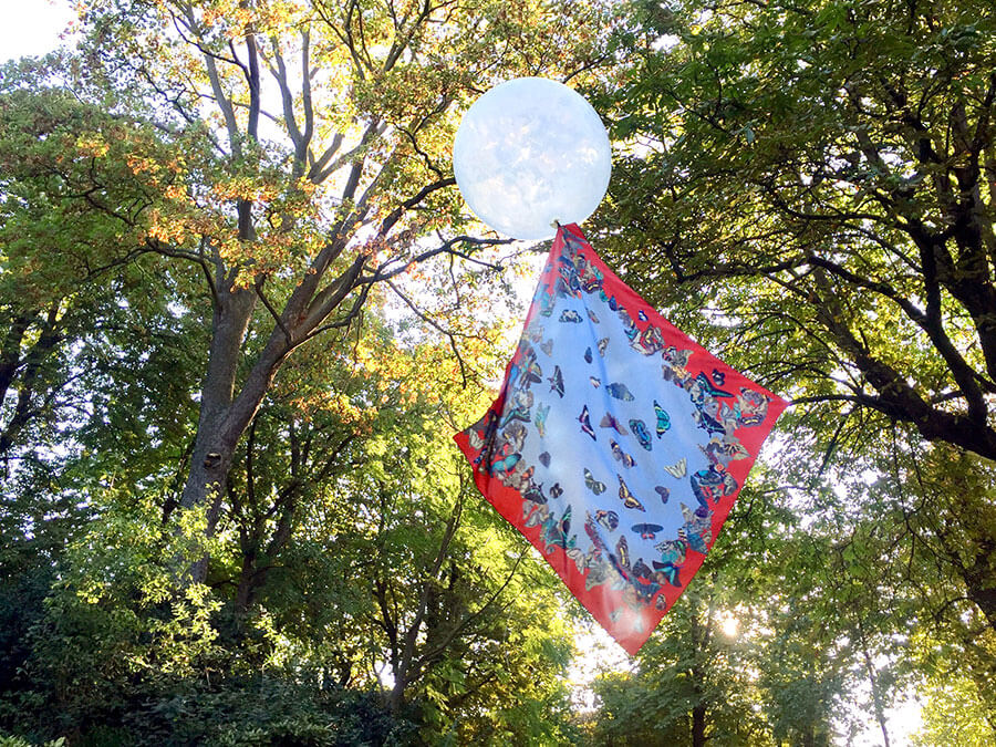 all over butterfly printed red and blue silk scarf on a balloon