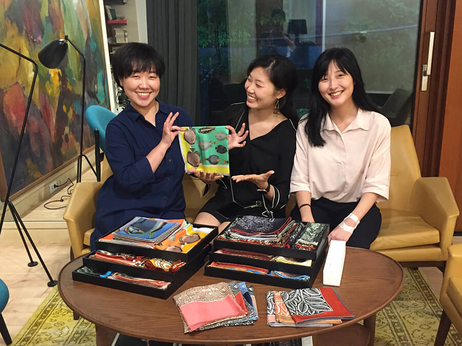 ladies looking at Mont Kiji scarves at the showroom in korea