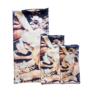 three folded scarves with dog prints