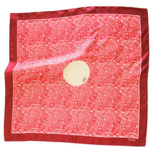 red pocket square with circle in the middle with initial