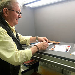 man checking lap dip colors with light box