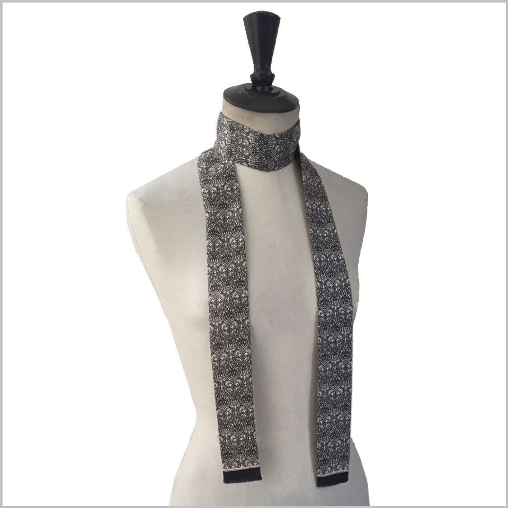 maannequin with long narrow printed silk twill scarf