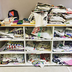 shelf with piles of printed silk color charts