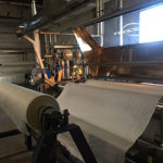 roll of silk fabric on the machine