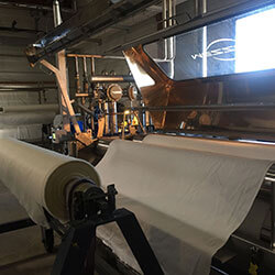 roll of silk fabric on the machine