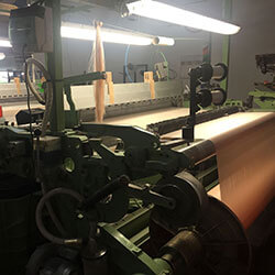 silk getting woven by machine