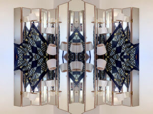 stripy fish scarf against multi faced mirror and lamps