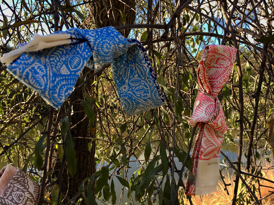 pink and blue long skinny silk scarves tied on a tree