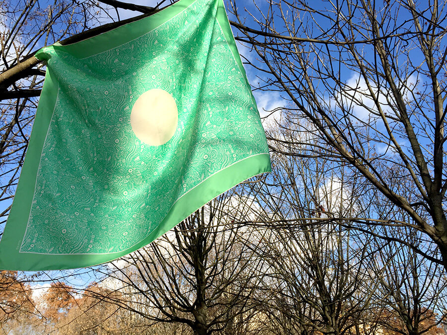 green silk scarf on trees against winter sky