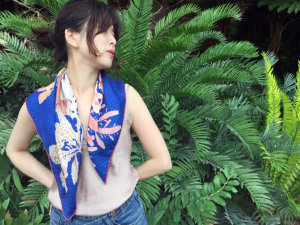 algae printed blue scarf on a woman by palm tree