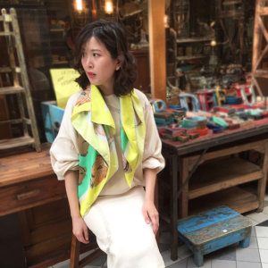 fish printed green silk scarf with lime boarder on woman