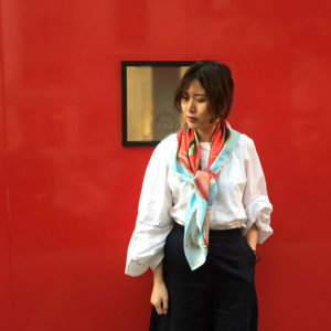 fish printed red silk scarf with blue boarder on woman