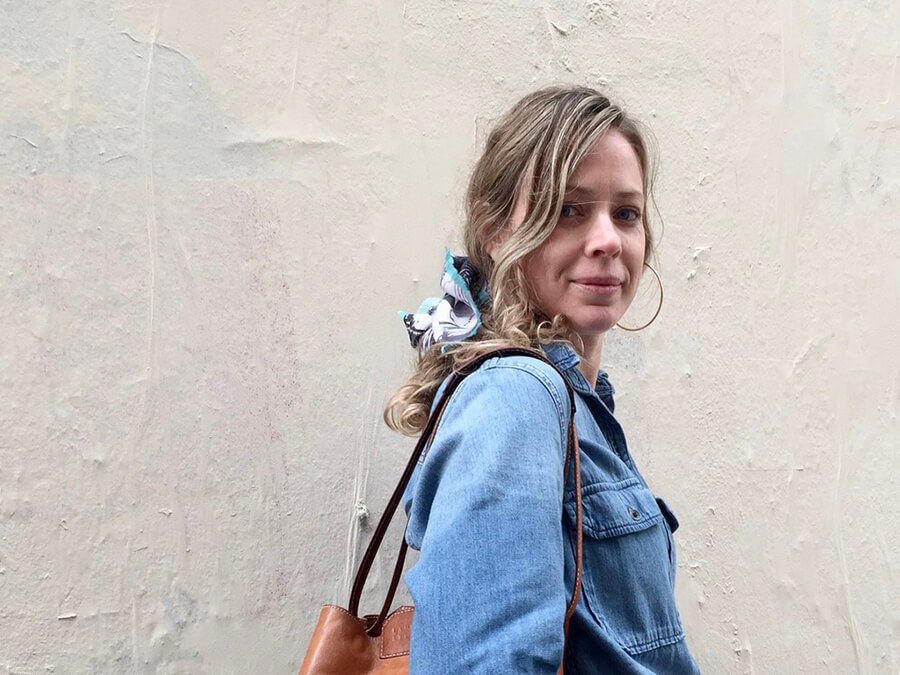 woman with black and white silk scarf with blue fringes on her hair