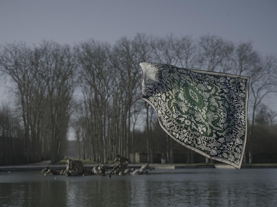 bandana style silk scarf floating over fountain with trees in the background