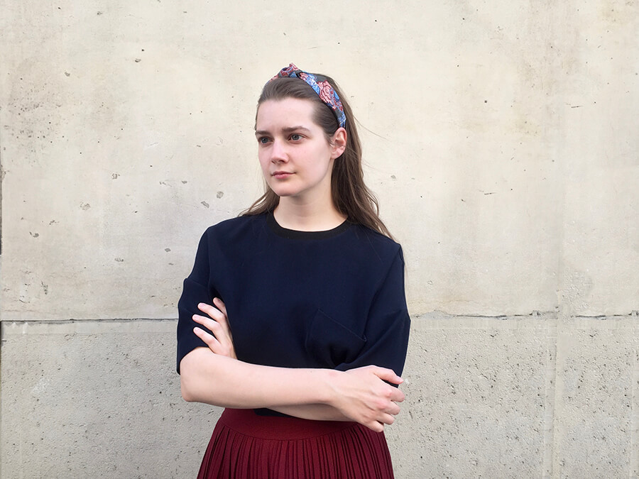 young lady wearing blue sweat shirt wearing a colourful hairband in her hair